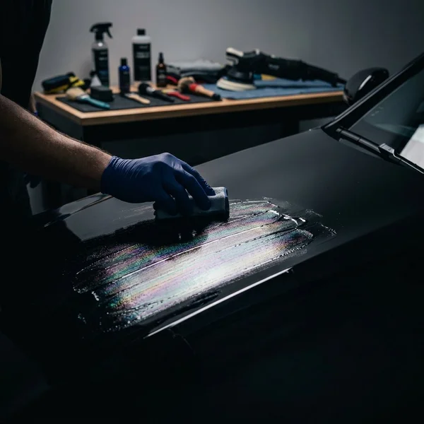 Black SUV after ceramic coating application showing dramatic paint reflections